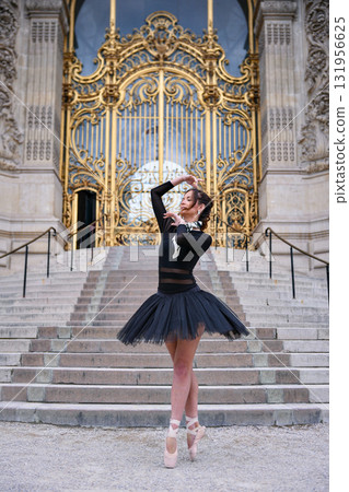 Ballet dancer posing near ornate Paris architecture  131956625