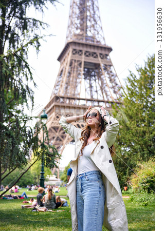 Fashionable woman enjoying sunny day near Eiffel Tower in Paris 131956630