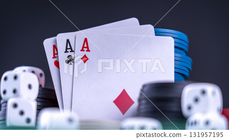 Three high-ranking cards against a backdrop of gaming chips. The essence of casino card games. Three high-ranking cards against a backdrop of gaming chips. The essence of casino card games. 131957195