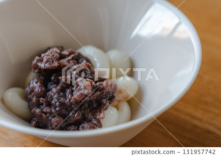 A Japanese-style sweet made with shiratama rice flour dumplings topped with plenty of bean paste A Japanese-style sweet made with shiratama rice flour dumplings topped with plenty of bean paste 131957742
