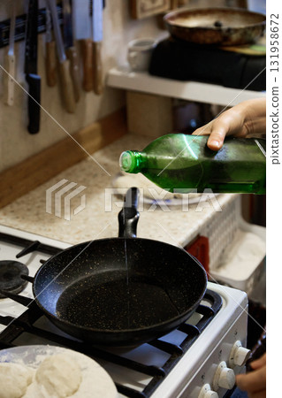 Adding Oil to Frying Pan for Cooking Adding Oil to Frying Pan for Cooking 131958672