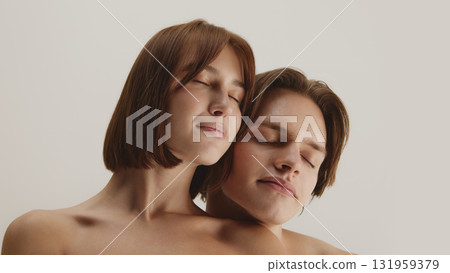 Couple with eyes closed leaning together in calm mindful relaxation Couple with eyes closed leaning together in calm mindful relaxation 131959379