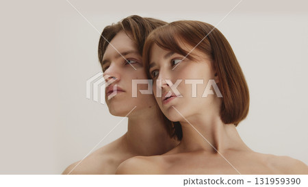 Modern artistic beauty portrait of couple looking aside in quiet balance Modern artistic beauty portrait of couple looking aside in quiet balance 131959390