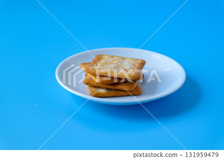 Crispy crackers or biscuits in white dish . Crispy crackers or biscuits in white dish . 131959479