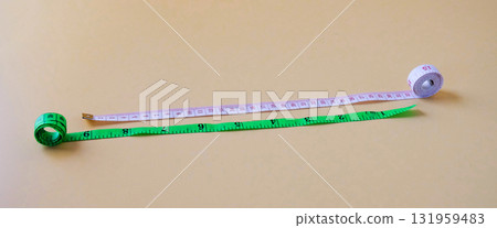 White and Green Measuring tape on color background. 131959483