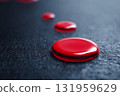 Red Paint Drop Creates a Striking Contrast on a Matte Black Surface Generative AI 131959629