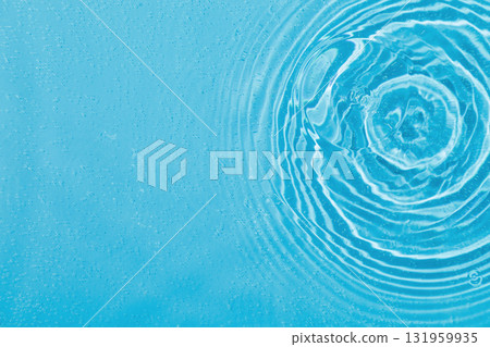 drops on water with circles on a blue background 131959935