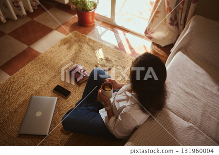 Cozy Home Office Moment With Laptop, Coffee, And Warm Sunlit Window 131960004