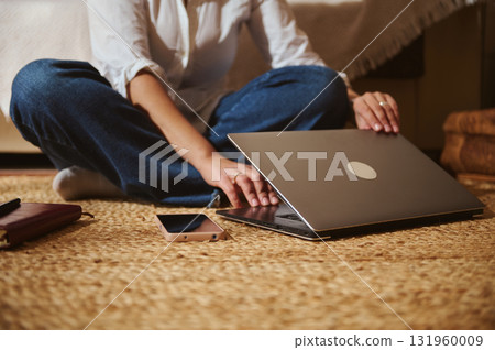 Casual Home Office Scene With Laptop, Phone, And Notebook On Living Room Rug Casual Home Office Scene With Laptop, Phone, And Notebook On Living Room Rug 131960009