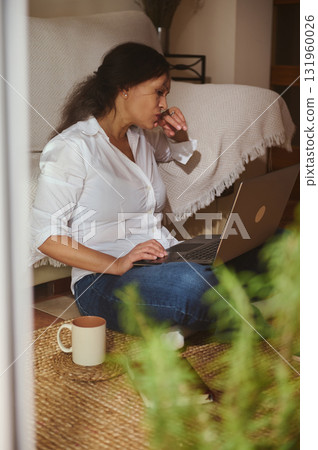 Woman Working From Home On Laptop, Cozy Indoor Scene With Coffee Mug Woman Working From Home On Laptop, Cozy Indoor Scene With Coffee Mug 131960026