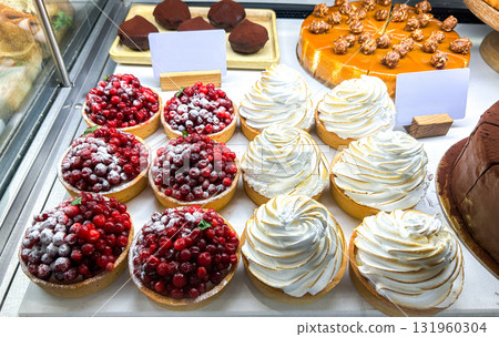 Bakery shop with assortment of cakes and sweet bakery cookery on shelves. High quality photo. Bakery shop with assortment of cakes and sweet bakery cookery on shelves. High quality photo. 131960304