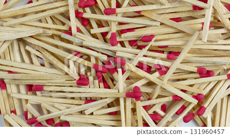 Wooden matches with red tips are scattered widely 131960457