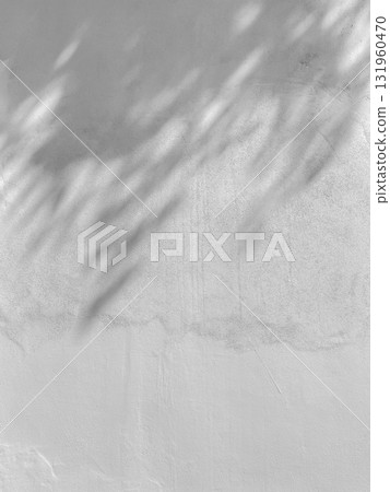 Shadows from leaves falling on textured wall 131960470