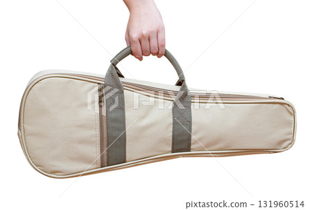 Hand holding beige ukulele case with transparent background 131960514