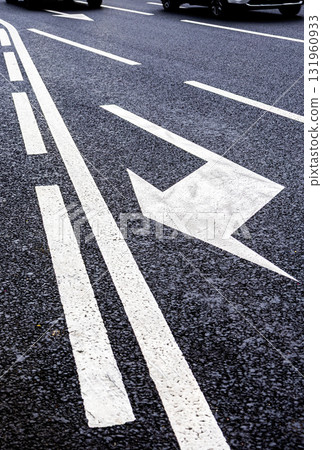 Traffic sign white arrows on asphalt road close up 131960933