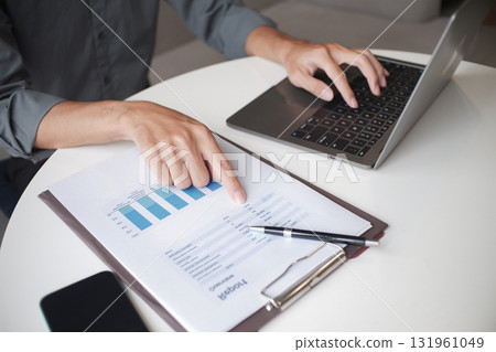 Closeup hand of unrecognizable businessman, entrepreneur, accountant, banker at the workplace 131961049