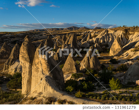 Strange rock formations illuminated by the morning sun in Cappadocia, Turkey 131961279