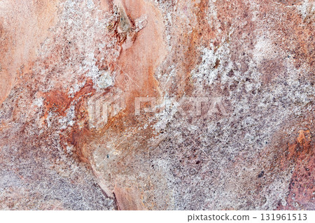 Close-up of a rugged rock surface featuring rust-orange hues, background texture Close-up of a rugged rock surface featuring rust-orange hues, background texture 131961513
