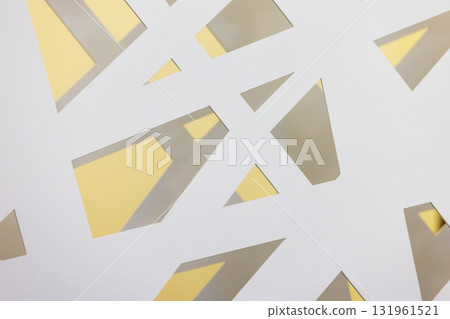 Abstract composition of white cutouts revealing warm yellow light behind Abstract composition of white cutouts revealing warm yellow light behind 131961521