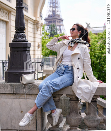 Trendy woman in casual outfit relaxing near Eiffel Tower in Paris Trendy woman in casual outfit relaxing near Eiffel Tower in Paris 131961579