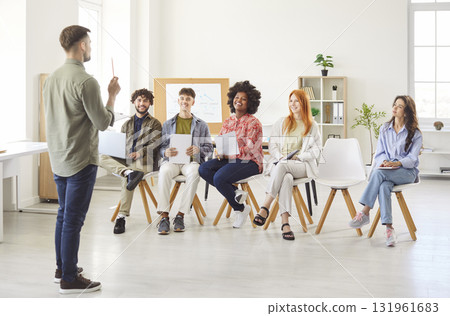 Businessman Leading A Meeting For Team Of Colleagues In Office Businessman Leading A Meeting For Team Of Colleagues In Office 131961683