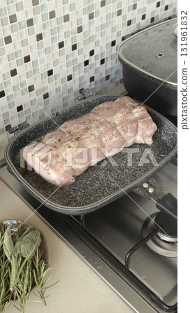Piece of pork fillet is fried in rectangular nonstick frying pan. Farm-grown ingredients and healthy eating at home. Piece of pork fillet is fried in rectangular nonstick frying pan. Farm-grown ingredients and healthy eating at home. 131961832