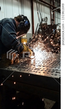 Witness the Skilled Welder in Action Sparks Fly from the Intense Metal Fabrication Process at the Workshop 131961849