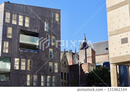 Modern and old architecture creating a contrast in an urban cityscape under bright blue sky. Antwerp, Belgium 131962184