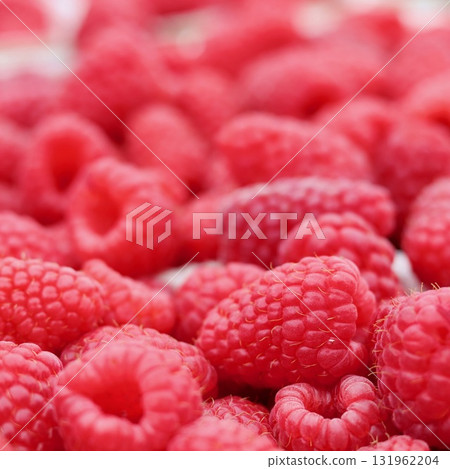 Ripe red raspberries filling the frame, creating a vibrant background texture of healthy natural fruit Ripe red raspberries filling the frame, creating a vibrant background texture of healthy natural fruit 131962204