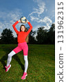 Young Woman in Vibrant Sportswear Enjoying Outdoor Soccer Practice on Sunny Day 131962315