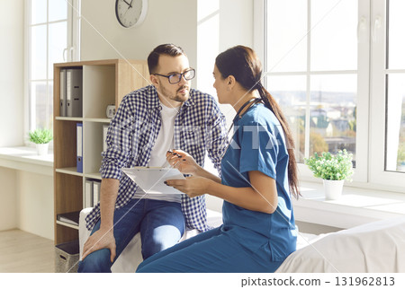 Young man patient visiting female nurse at doctor office during medical examination. Young man patient visiting female nurse at doctor office during medical examination. 131962813
