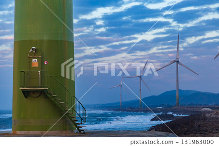 White wind turbines stand on the coast 131963000