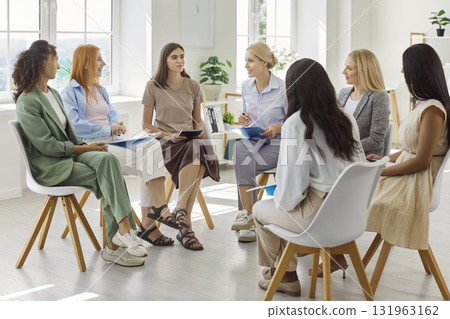Diverse women team in group meeting, coaching circle training discussion Diverse women team in group meeting, coaching circle training discussion 131963162
