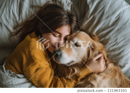 Girl Cuddles Golden Retriever on a Cozy Bed During a Relaxing Morning at Home Girl Cuddles Golden Retriever on a Cozy Bed During a Relaxing Morning at Home 131963391