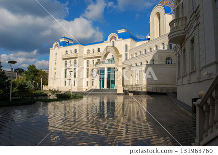 The building of the international academic school in Odessa. The richly decorated building with neoclassical architecture has a central golden dome topped with a cross. The building of the international academic school in Odessa. The richly decorated building with neoclassical architecture has a central golden dome topped with a cross. 131963760