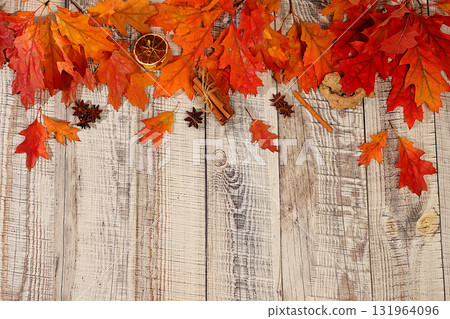 Frame with maple leaves, cinnamon, nuts, anise, autumn abstract composition, Thanksgiving concepts, seasonal background, greeting card or invitation, screen banner, autumn greeting concept. 131964096