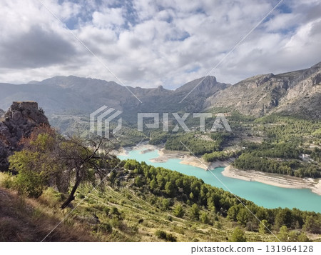 Stunningly Beautiful Mountain Landscape Showcasing Clear, Turquoise Water Beneath a Blue Sky 131964128