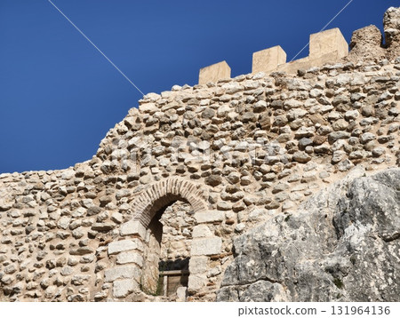 The historic stone fortress stands tall against the blue sky, embodying timeless beauty 131964136