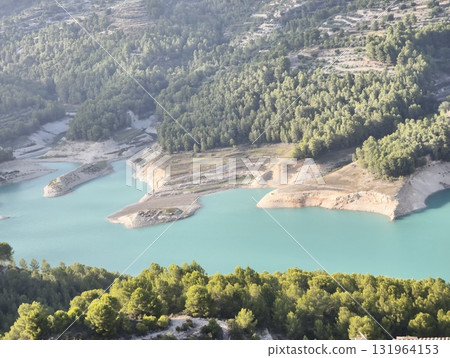 Breathtaking Aerial View of a Tranquil Lake that is Beautifully Surrounded by Lush Green Forest 131964153