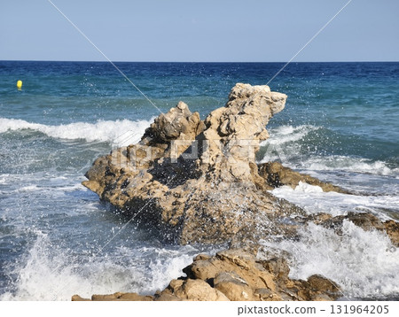 A Truly Stunning Lone Rock Formation Rising Majestically in the Midst of the Ocean Waves 131964205