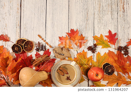 Seasonal abstract composition with hot autumn drink, coffee with foam, and Indian masala chai and fallen leaves, star anise and cinnamon, banner for screen, autumn greeting concept, mockup for menu. Seasonal abstract composition with hot autumn drink, coffee with foam, and Indian masala chai and fallen leaves, star anise and cinnamon, banner for screen, autumn greeting concept, mockup for menu. 131964207