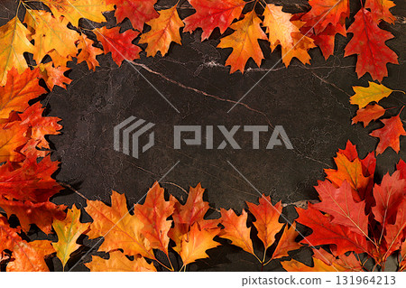 Frame with maple leaves on marble background, autumn abstract composition, Thanksgiving concepts, seasonal background, greeting card or invitation, banner for screen, autumn greeting concept. Frame with maple leaves on marble background, autumn abstract composition, Thanksgiving concepts, seasonal background, greeting card or invitation, banner for screen, autumn greeting concept. 131964213