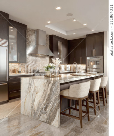 Stunning contemporary luxury kitchen with dark wood cabinetry and a centerpiece natural stone waterfall island. Features a metallic mosaic backsplash, stainless steel appliances, elegant bar stools. 131964311
