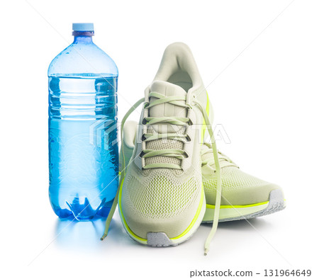 Sport running shoes and water bottle  isolated on white background. 131964649