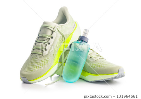 Sport running shoes and water bottle  isolated on white background. 131964661