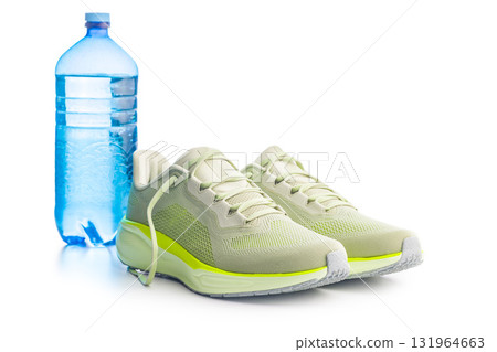 Sport running shoes and water bottle  isolated on white background. Sport running shoes and water bottle  isolated on white background. 131964663