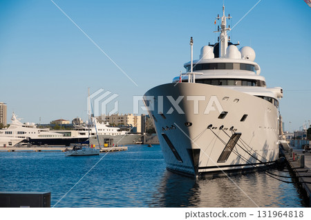 A huge white yacht moored at the dock A huge white yacht moored at the dock 131964818