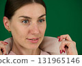 Set of photos of young European woman in light blazer and blue jeans showing various emotions gestures and expressions on green chroma key background with copy space for advertising and social media 131965146