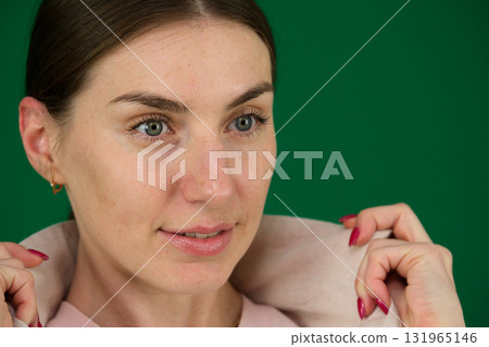 Set of photos of young European woman in light blazer and blue jeans showing various emotions gestures and expressions on green chroma key background with copy space for advertising and social media 131965146