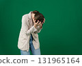 Set of photos of young European woman in light blazer and blue jeans showing various emotions gestures and expressions on green chroma key background with copy space for advertising and social media 131965164
